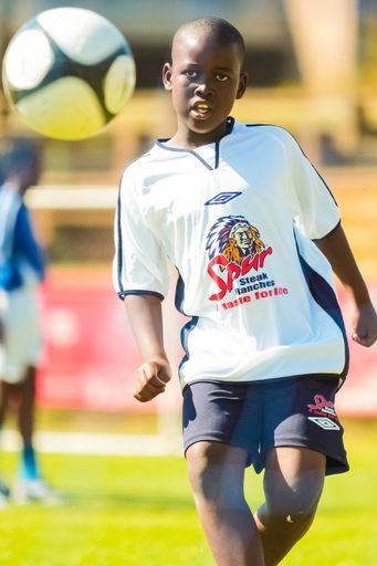 Johannesburg, South Africa - June 29 2009:  Diverse children playing soccer football at school