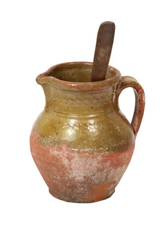 A vertical shot of a clay jug isolated on white background