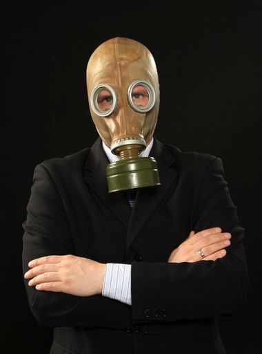 A vertical shot of a man wearing a gas mask