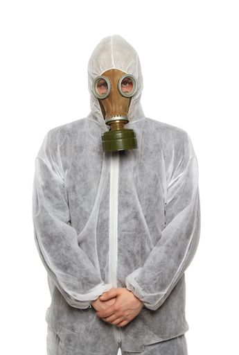 A vertical closeup shot of a scientist wearing a gas mask on a white background