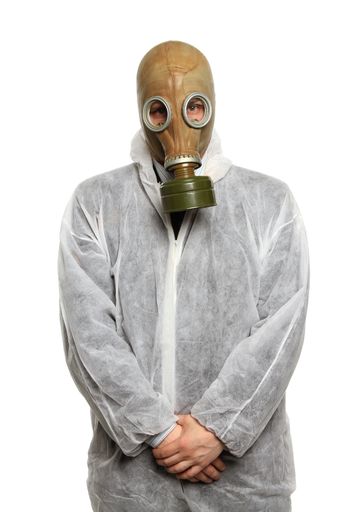 A vertical closeup shot of a scientist wearing a gas mask on a white background