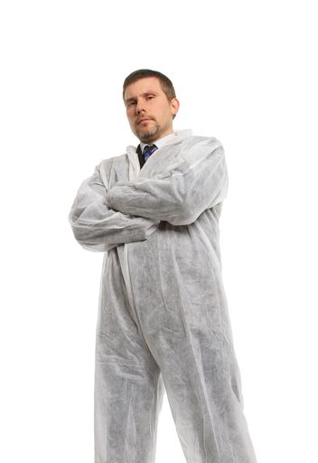 A male in full protective clothing with crossed arms isolated on a white background