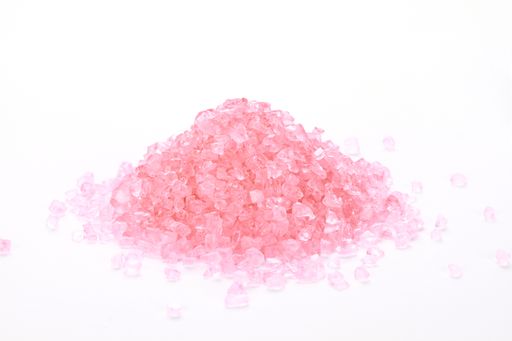 A pile of pink bath salt isolated on a white background