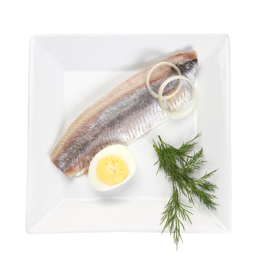 A vertical top view shot of a fish meal on a white surface