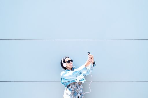 A portrait of a young woman taking a selfie outdoors