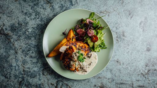 A top view of healthy plate with chicken in the sauce, potato and salad