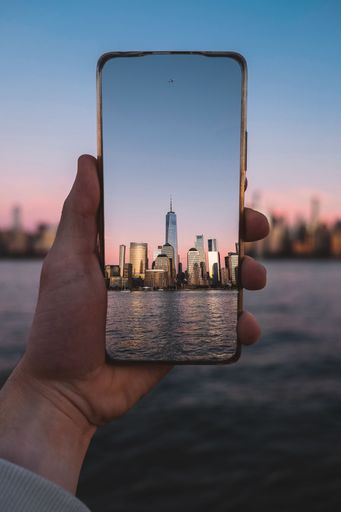 A person taking a picture of New York skyline with a phone