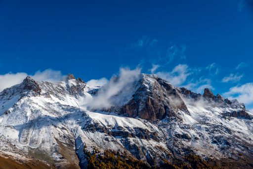 The Himalayas covered in snow against the blue sky