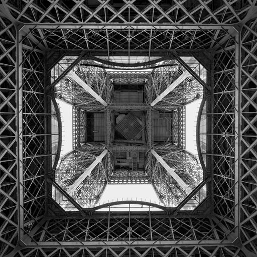 A low angle grayscale shot of the Eiffel tower from the inside in Paris, France