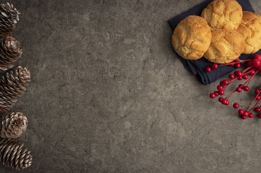 A top view of Christmas background with sweets, red berries and pine cones