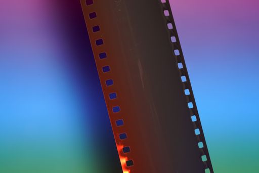 A top view shot of a film reel on a colorful surface