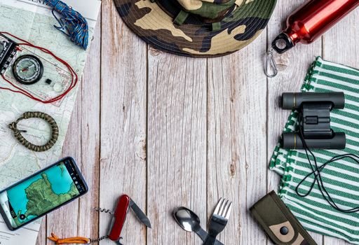 The flat lay of hiking equipment  with the copy space in the center