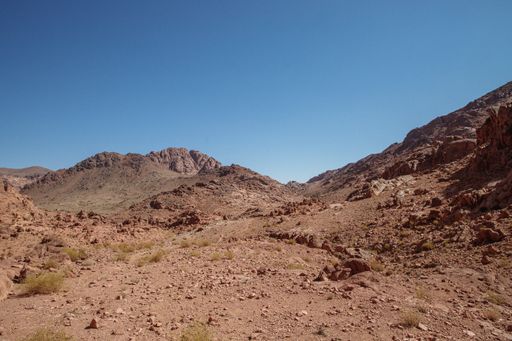 A landscape of rocky hills under the sunlight and a blue sky in the countryside