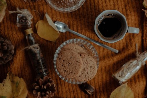 An overhead shot of tasty cookies and coffee in an autumn decoration set
