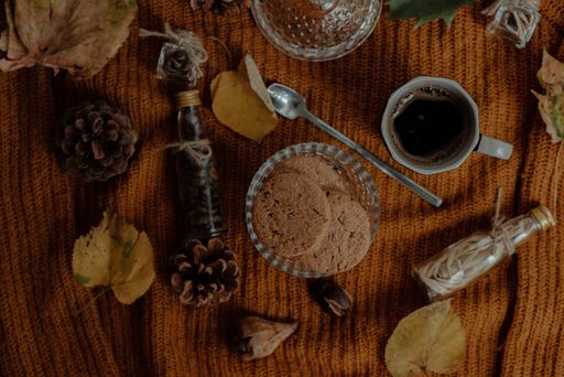 An overhead shot of tasty cookies and coffee in an autumn decoration set