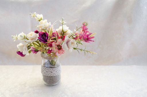 A closeup high angle shot of a flower bouquet on a white surface