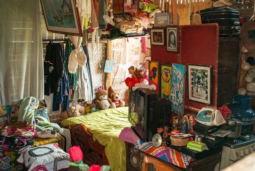 Itagui, Colombia - March 15 2019: Room full of Things,  Decorated with Pictures, Bed, Kitchen, Iron many Suitcases and Clothes Everywhere