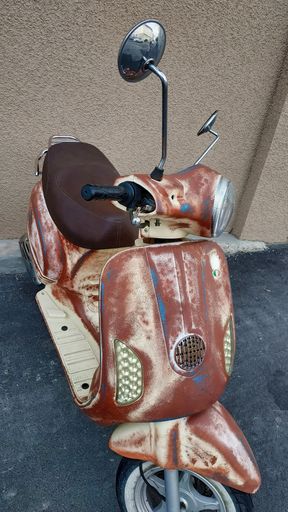 A closeup of an old vintage scooter