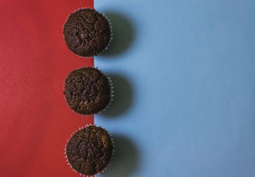 A top view of tasty cupcakes isolated red and blue background