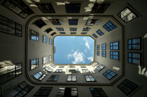 A low angle shot of a rectangular-shape building under the sunlight and a blue sky - perfect for wallpapers