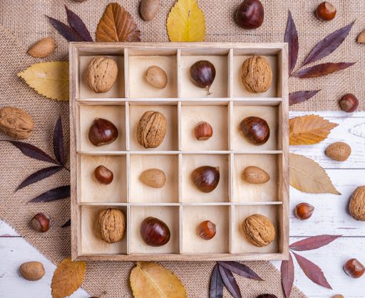A top view of different kinds of nuts in a wooden box