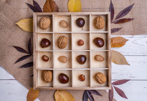 A top view of different kinds of nuts in a wooden box