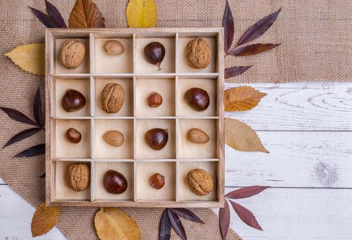 A top view of different kinds of nuts in a wooden box