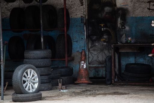 A stack of tires for sale in an old car garage