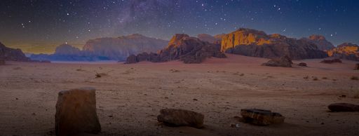 Desert and rocks on extraterrestrial or alien planet in the universe with view on space and galaxy. Sci-fi simulation.