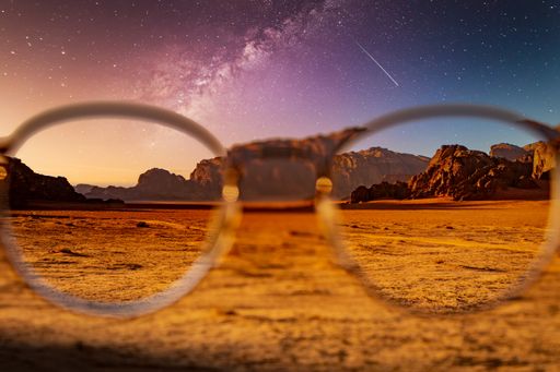 Desert and rocks on extraterrestrial or alien planet in the universe with view on space and galaxy. Sci-fi simulation.