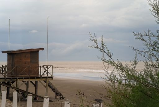 The wooden lifeguard cabin under a cloudy sky. El Silvio beach, Mar de Ajo, Buenos Aires, Argentina