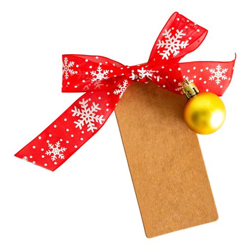 A closeup shot of a craft paper tag with red ribbon and a mini Christmas ornament on white background