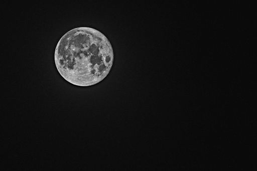 A beautiful view of a moon in the dark black sky at night