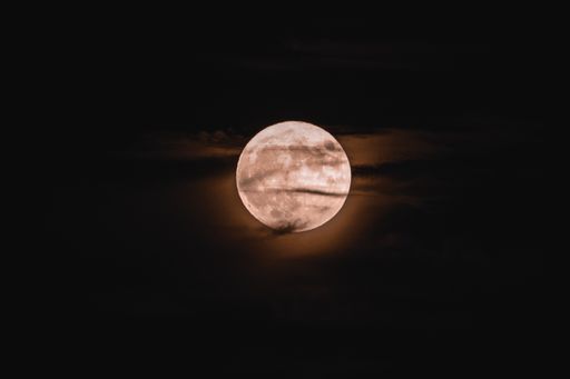 A bright full moon captured in the dark sky at night