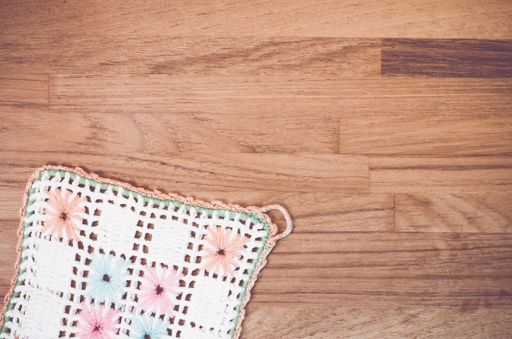 A high angle shot of handmade crochet on a wooden surface