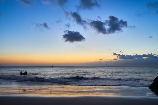 A mesmerizing view of the sunset over the sandy seashore