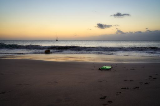 A mesmerizing view of the sunset over the sandy seashore
