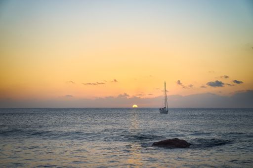 A mesmerizing view of the sunset over the sandy seashore