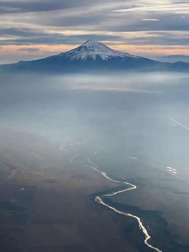 A vertical shot of a mountain covered in snow and the beautiful landscape
