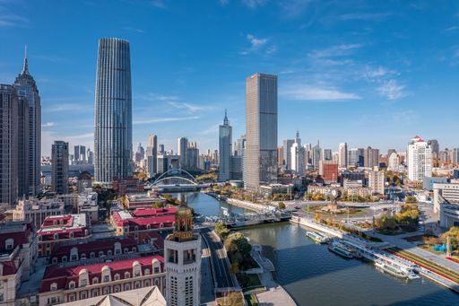 A high-angle view of a city full of skycrapers under the blue sky.