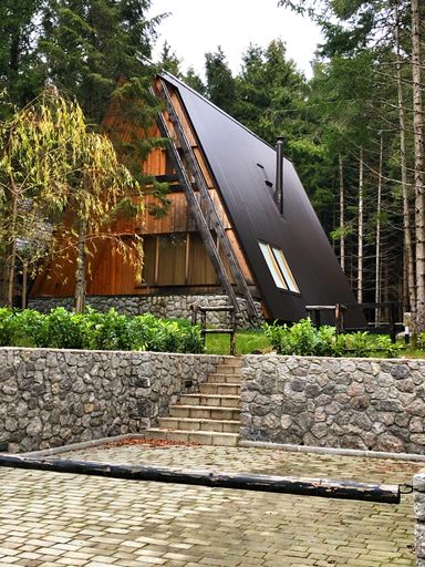 A beautiful small A-Frame wood cabin in a forest