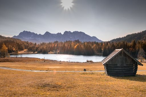 A closeup shot of a small house near the lake in the mountains