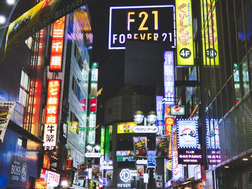 A low angle view of Neon lights and signs from the Shibuya district, Tokyo, Japan