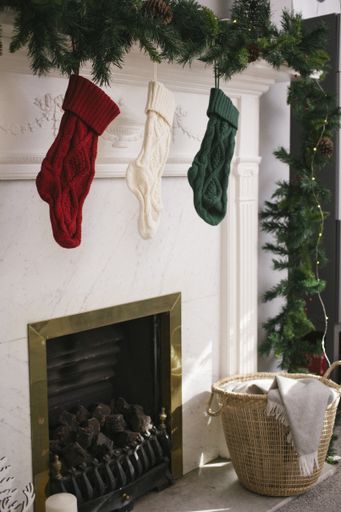 the vertical shot of socks hung from a green chain under the mirror