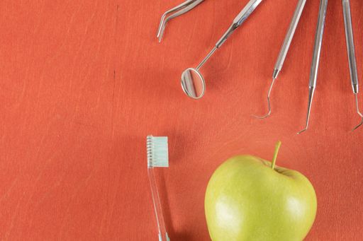A set of dentist tools on wooden background
