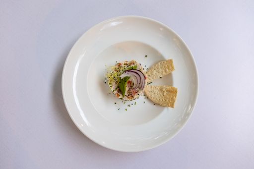 A top view of a unique salad on a white plate laid on a table