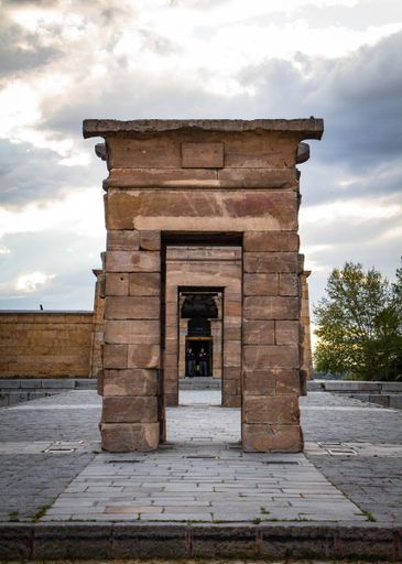 A vertical shot of the  ancient Egyptian Temple of Debod in Madrid under the cloudy sky