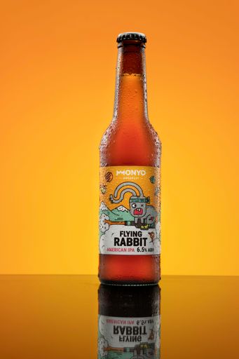 A product shot of a beer with a yellow background