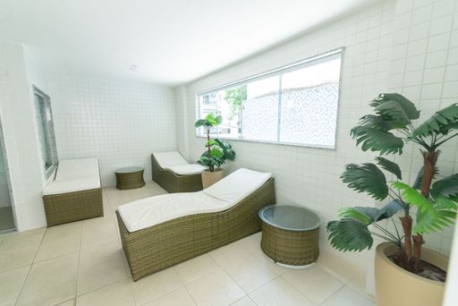 The room in white colors for a relaxation area with beds and plants
