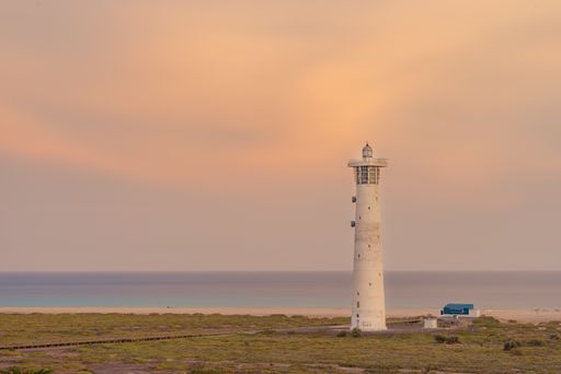 A majestic sunset cloudscape over a Morro Jable Lighthouse on the Canary island of Fuerteventura, Spain